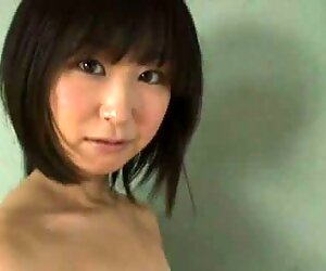 Whorish Japanese gal Yumi Ishikaw poses on a cam wearing ripped off top